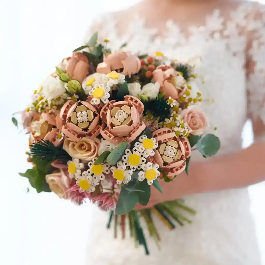 Bride holding a LEGO flower wedding bouquet made with pink roses and daisies.