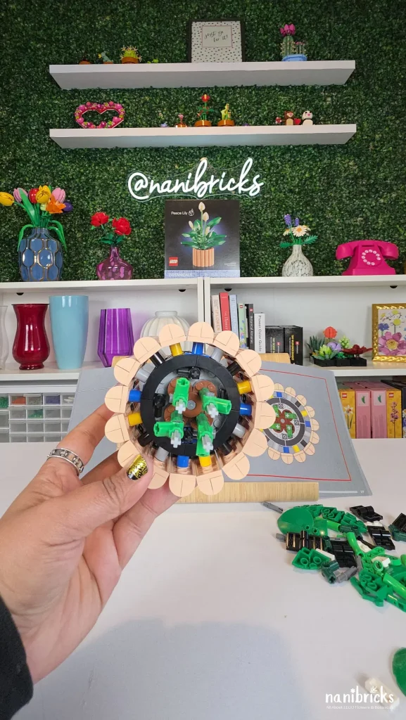 Top-down view of the LEGO Botanicals Peace Lily pot with green leaf connection points added during Bag 3.