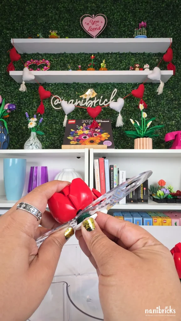 Using an inverted radar piece to secure a LEGO rose inside a heart-shaped vase