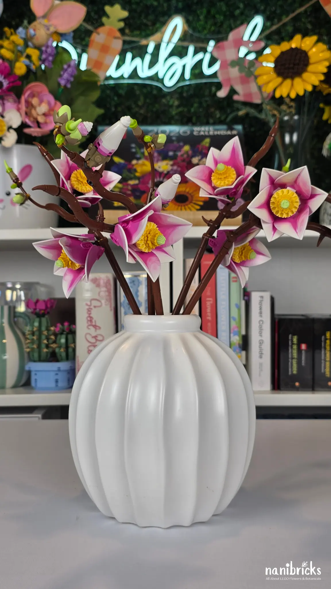 LEGO Botanicals Magnolia Branches 11510 displayed in a white vase with pink flowers
