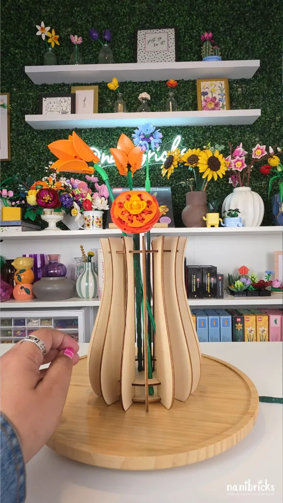 Adding blue cornflower to LEGO flower arrangement for color contrast