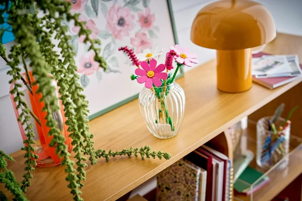 LEGO Botanicals Cosmos Flowers 11514 displayed in a glass vase on a shelf as home decor
