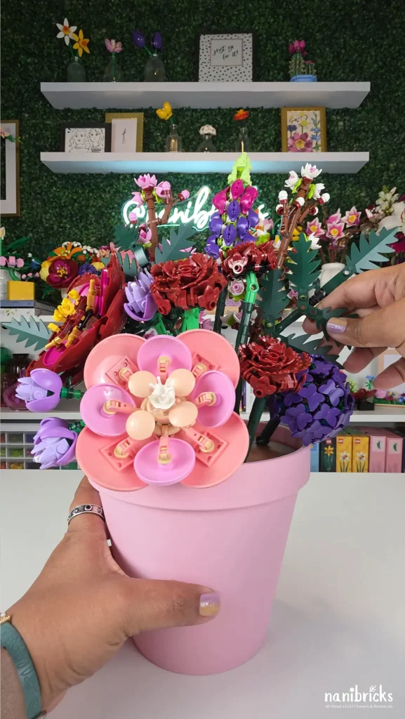 Adding LEGO filler flowers and greenery to soften a custom flower arrangement and fill empty spaces