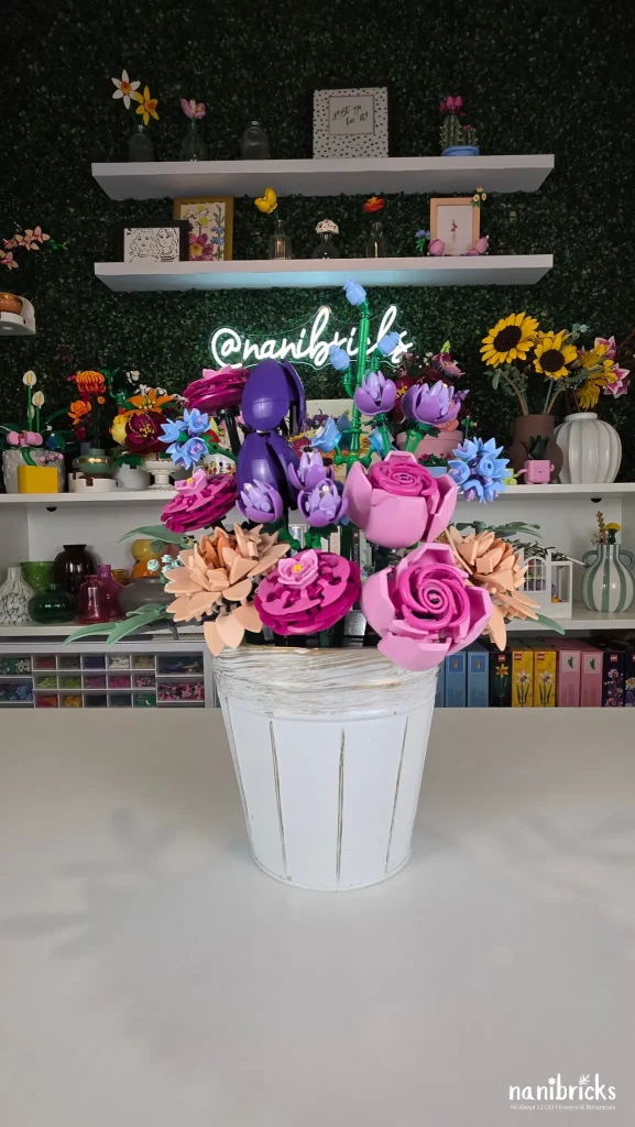 Blush Garden Bloom LEGO flower arrangement displayed in a white distressed metal planter with pink, purple and blue LEGO flowers