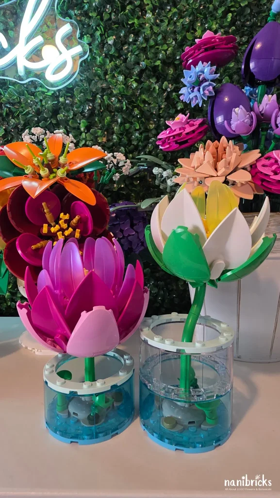 LEGO Botanicals Water Lilies 11511 displayed beside other LEGO flower arrangements, highlighting the transparent water-effect vases