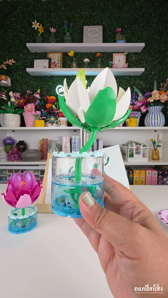 Finished white water lily from LEGO Botanicals Water Lilies 11511 displayed in a tall transparent water-effect vase
