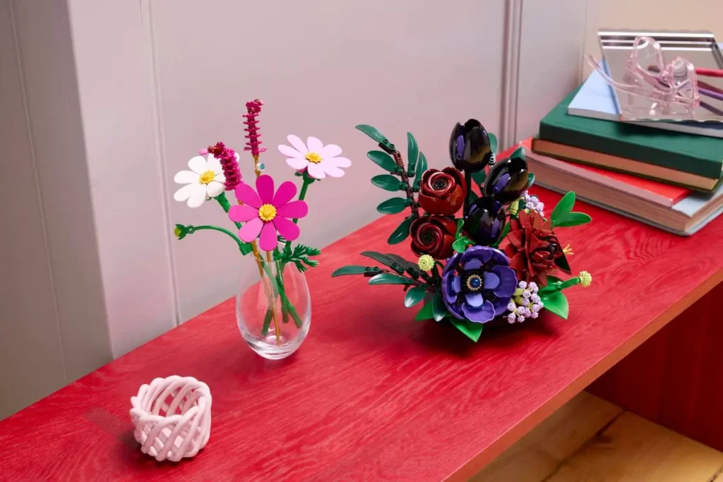 LEGO Botanicals Dark Flower Arrangement (11513) displayed next to a colorful LEGO flower arrangement.