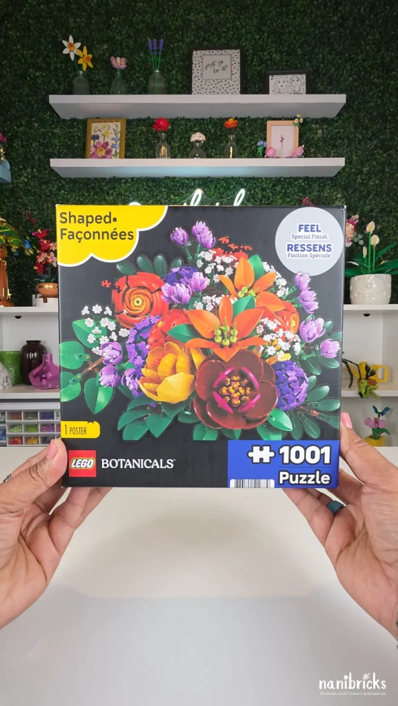 Front of the LEGO Botanicals Purple Flower Arrangement Puzzle box featuring a die-cut bouquet with purple, orange, yellow, and burgundy LEGO flowers