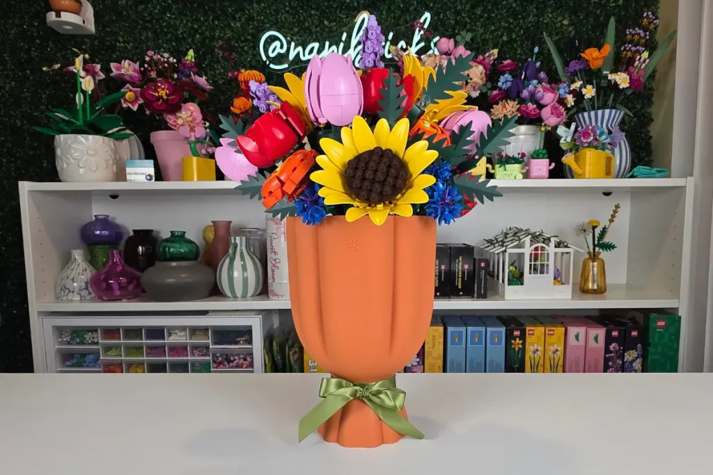 Sunshine Garden LEGO flower arrangement with yellow sunflowers, red roses, pink tulips, orange ranunculus, lavender, blue cornflowers, and cow parsley in a peach-colored LEGO vase.